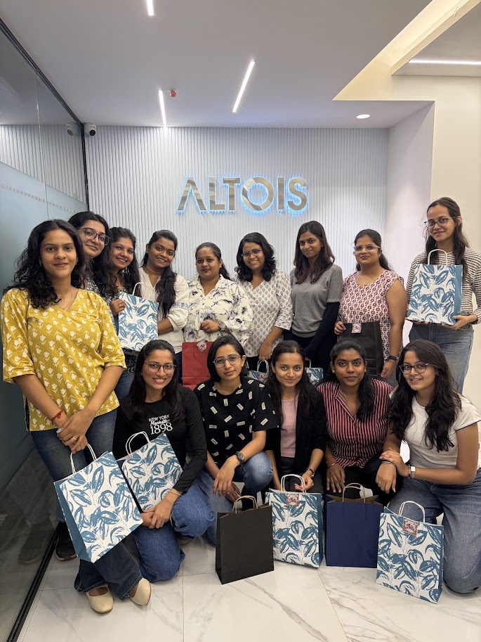Altois team celebrating with gift bags at the office reception